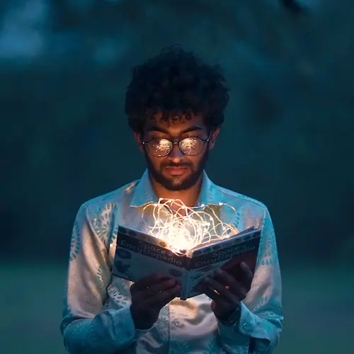 A man reading a book independently at home